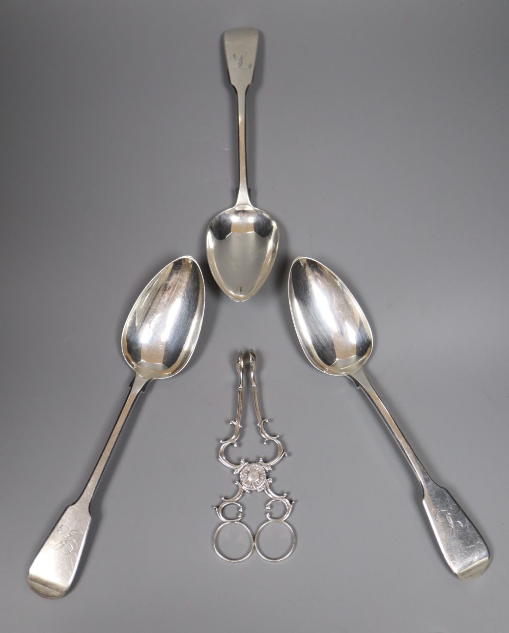 A set of three George III silver tablespoons, maker (probably) Thomas Dicks, London 1820 and a pair of George II silver sugar nips,